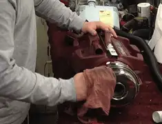 Vacuum repair technician cleaning and servicing a vacuum motor in Kansas City, MO